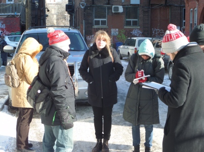 Jason from Tour Guys gives the U of T Anthropology students an introduction to Kensington Market on a cold January Day